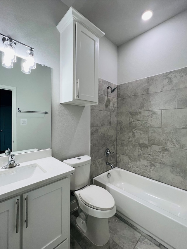 full bathroom featuring vanity, toilet, and tiled shower / bath