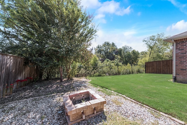 view of yard with an outdoor fire pit