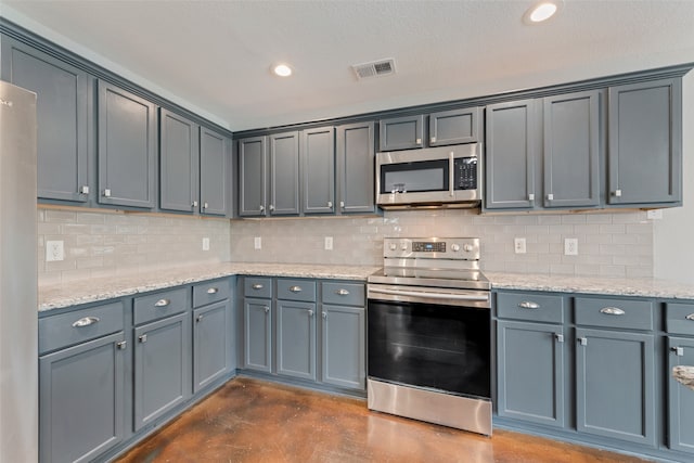 kitchen featuring a textured ceiling, appliances with stainless steel finishes, backsplash, and gray cabinetry