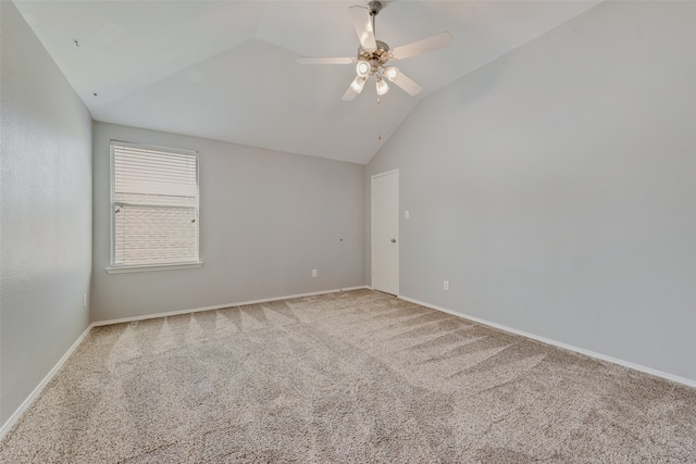 carpeted empty room featuring vaulted ceiling and ceiling fan