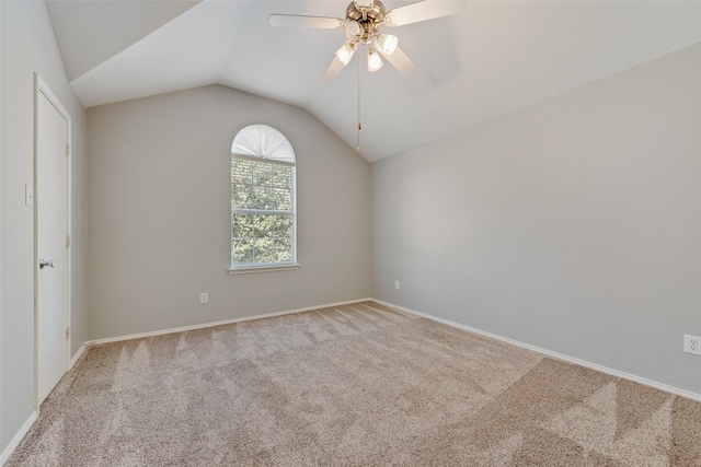 unfurnished room featuring light carpet, vaulted ceiling, and ceiling fan