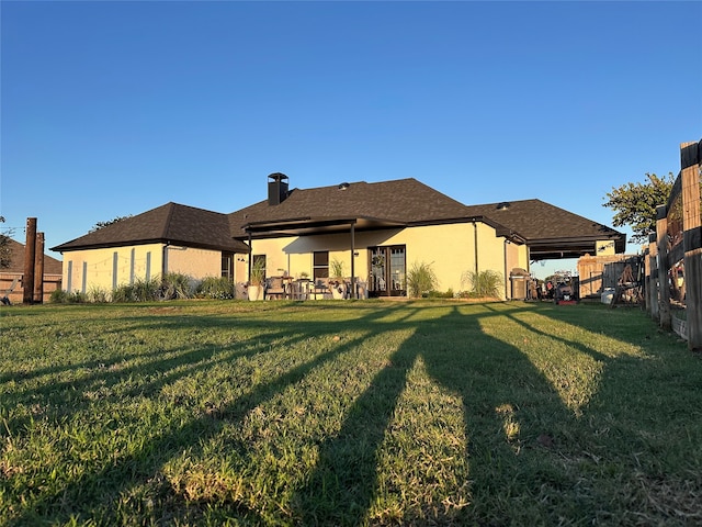 back of house with a yard and a patio area