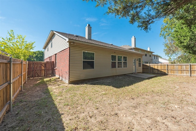 1200 Scenic Hills Dr, Mckinney, TX 75071 - back of house featuring a chimney, a fenced backyard, a yard, and brick siding