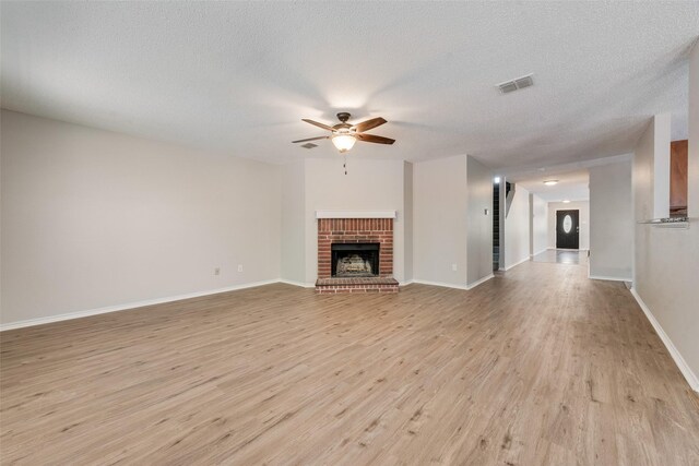 1200 Scenic Hills Dr, Mckinney, TX 75071 - unfurnished living room featuring light wood-type flooring, a ceiling fan, visible vents, and a textured ceiling