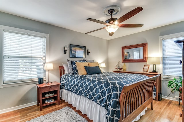 bedroom with ceiling fan and light hardwood / wood-style floors