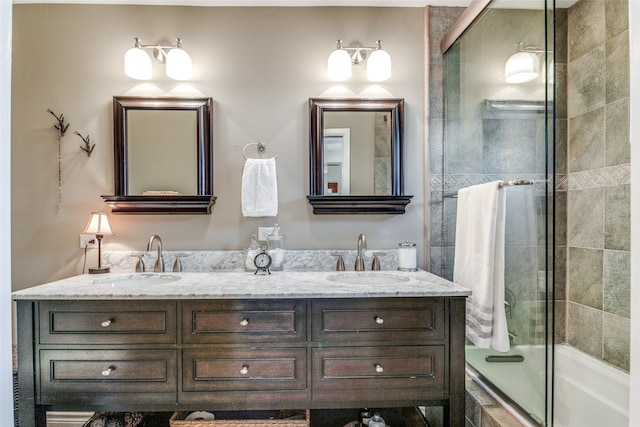 bathroom featuring vanity and bath / shower combo with glass door