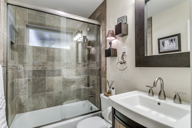 full bathroom featuring enclosed tub / shower combo, vanity, and toilet