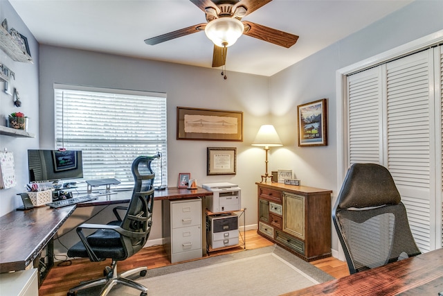 home office featuring light hardwood / wood-style floors and ceiling fan