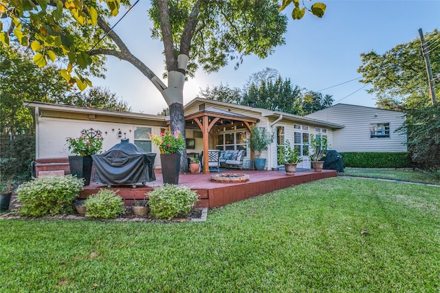 rear view of house with a yard and a deck