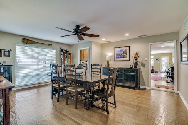 dining area with ceiling fan and light hardwood / wood-style floors