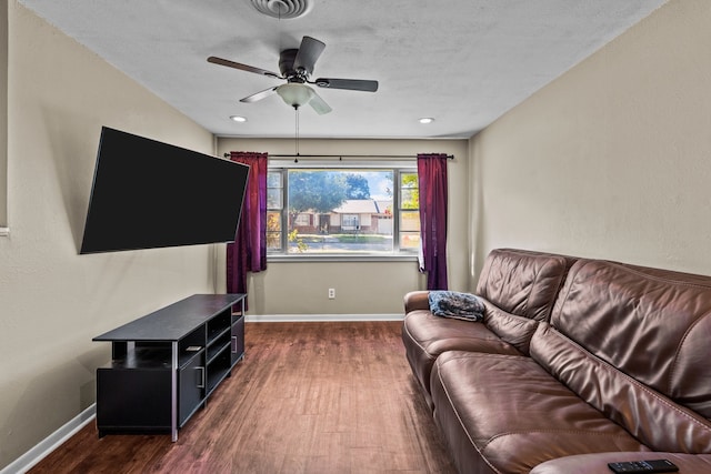 living room featuring dark hardwood / wood-style floors and ceiling fan