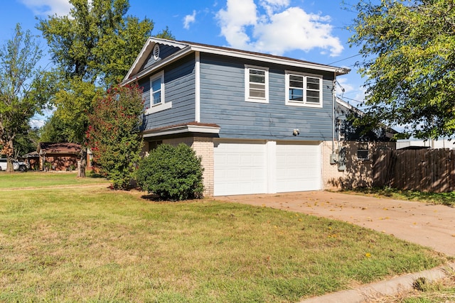 view of side of property with a lawn and a garage