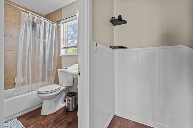 bathroom featuring shower / bathtub combination with curtain, hardwood / wood-style flooring, and toilet