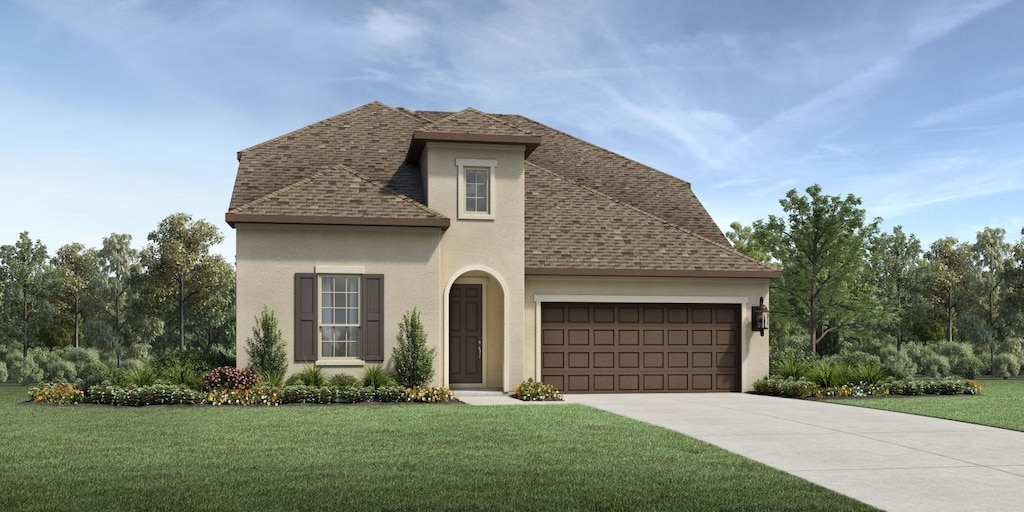 view of front of house with a garage and a front lawn