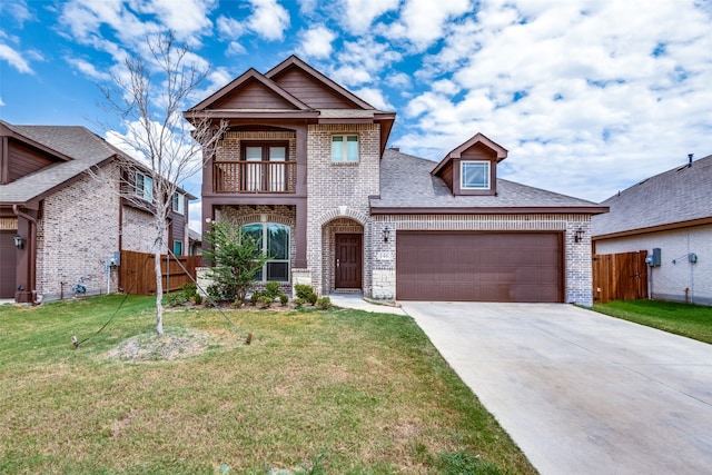 view of front of house featuring a garage, a balcony, and a front lawn