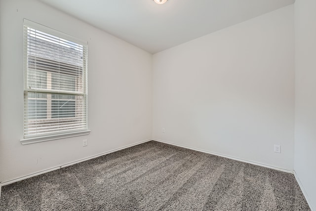 carpeted spare room with a healthy amount of sunlight