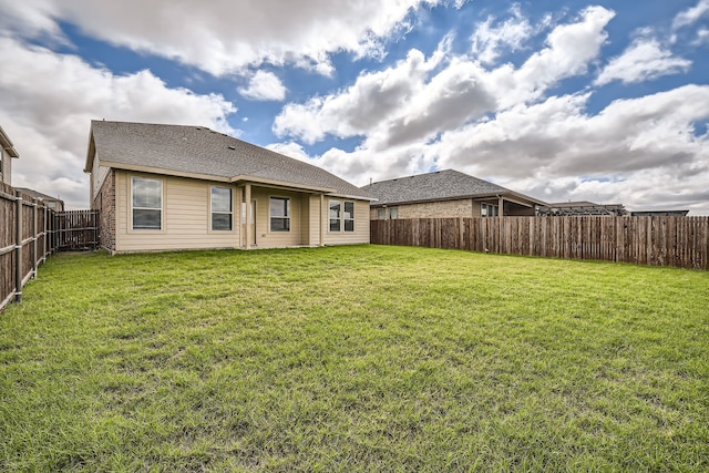 back of house with a yard