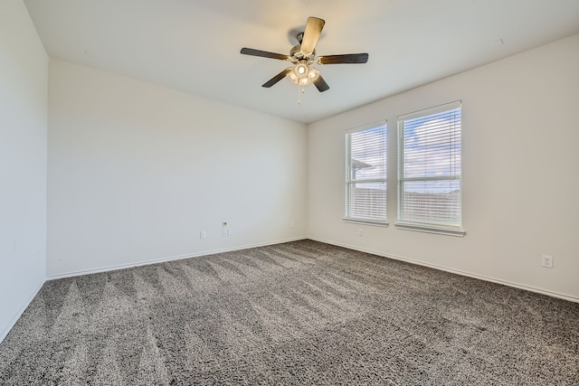 empty room featuring dark colored carpet and ceiling fan