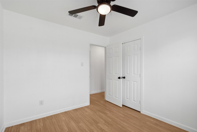 unfurnished bedroom with a closet, ceiling fan, and light hardwood / wood-style flooring