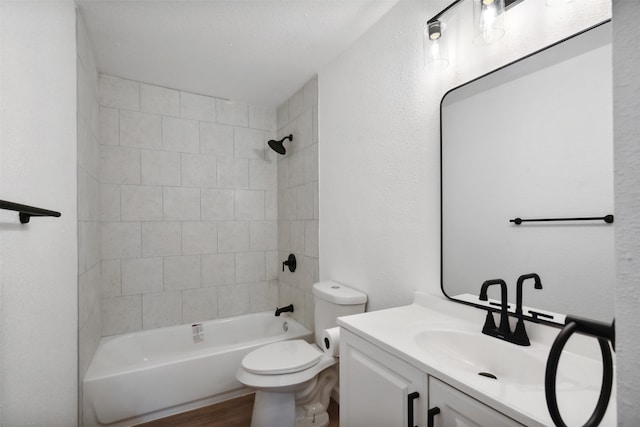 full bathroom featuring hardwood / wood-style flooring, vanity, toilet, and tiled shower / bath combo