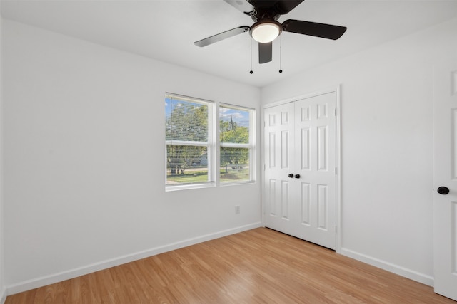 unfurnished bedroom featuring ceiling fan, a closet, and light hardwood / wood-style floors