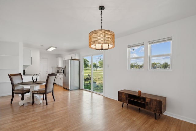 dining space with light wood-type flooring