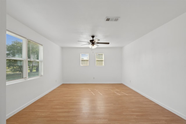 empty room with ceiling fan and light wood-type flooring