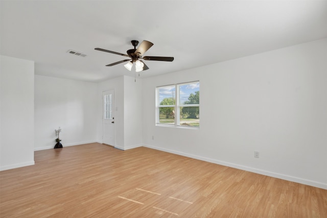 spare room with ceiling fan and light wood-type flooring