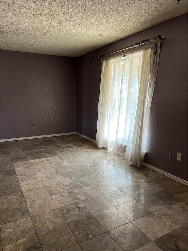 spare room featuring a textured ceiling