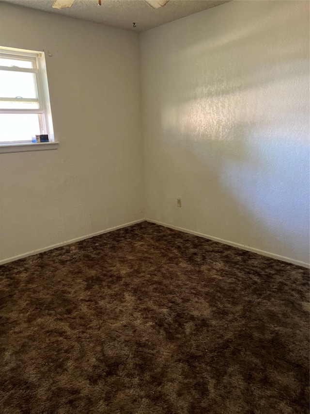 empty room with carpet flooring, a textured ceiling, and ceiling fan