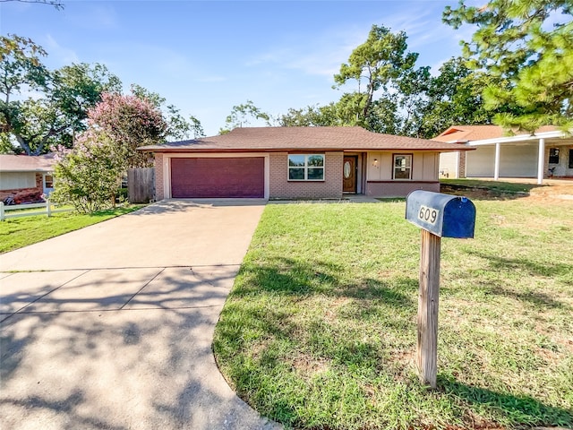 ranch-style home with a garage and a front lawn