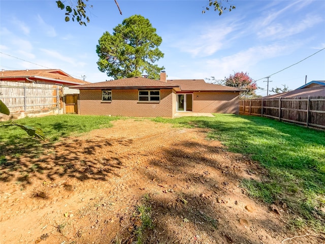 rear view of house with a yard