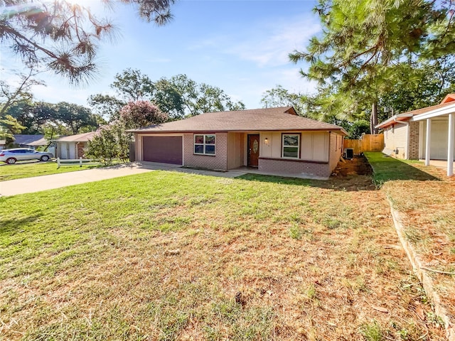 ranch-style home with a garage and a front yard