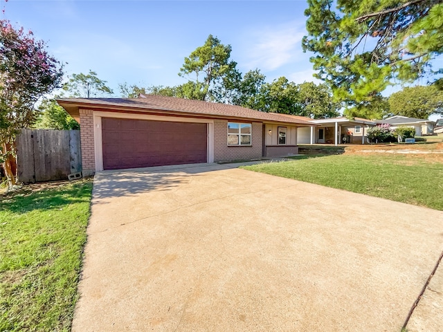 ranch-style home with a garage and a front lawn