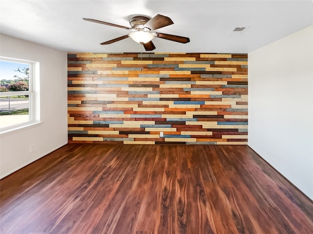 empty room featuring ceiling fan and dark hardwood / wood-style floors