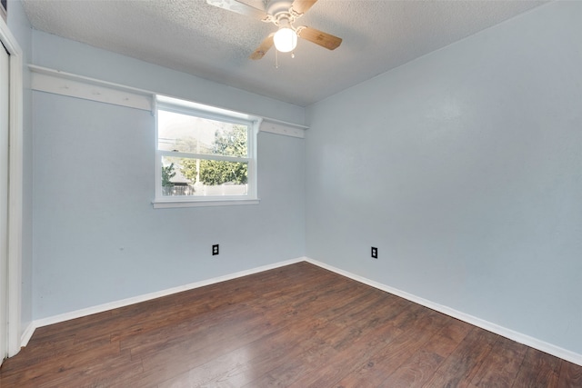 empty room with ceiling fan, a textured ceiling, and dark hardwood / wood-style flooring