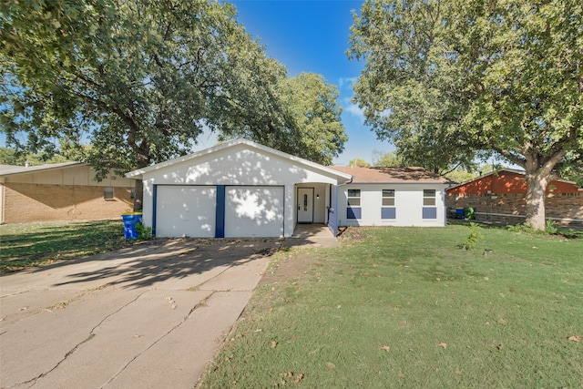 single story home with a garage and a front lawn