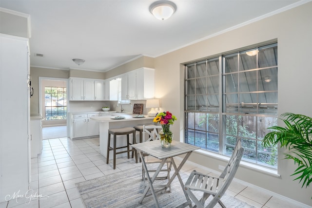 tiled dining space with ornamental molding and sink