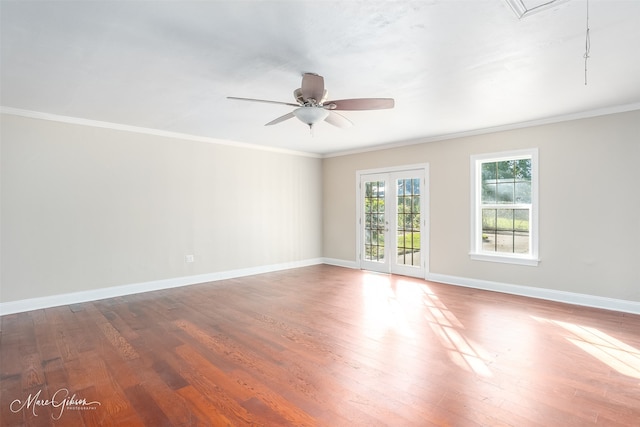 spare room featuring ceiling fan, ornamental molding, and wood-type flooring