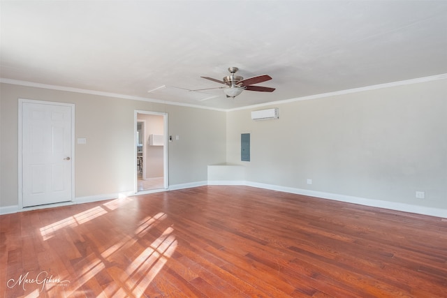 spare room with ceiling fan, electric panel, ornamental molding, wood-type flooring, and a wall unit AC