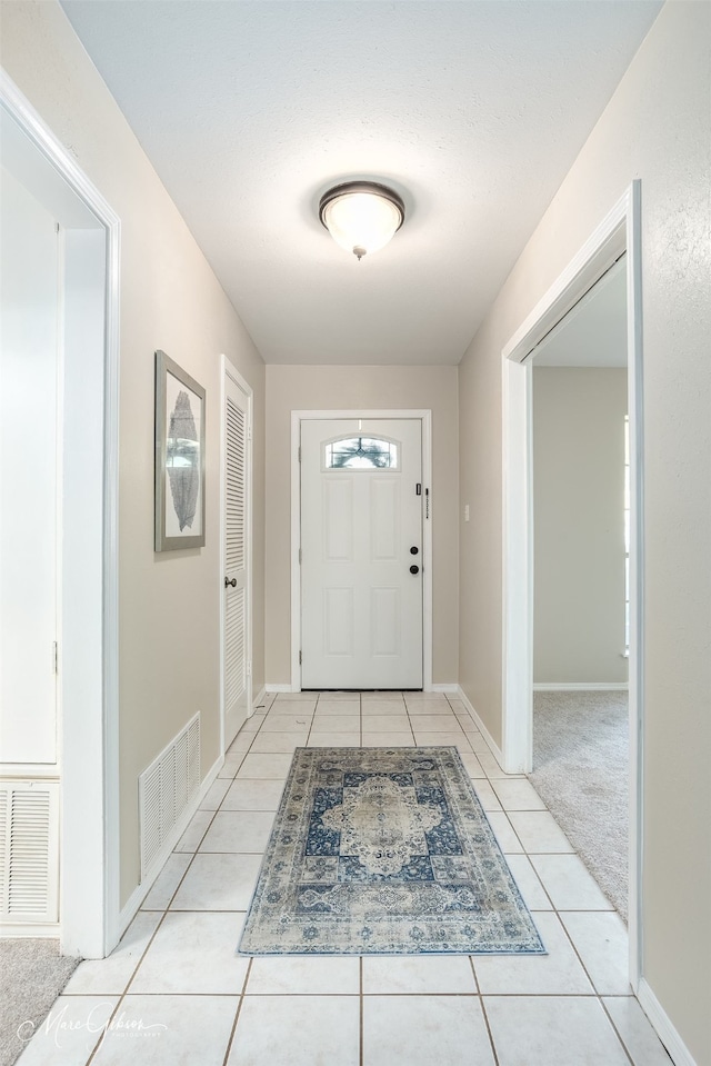 doorway to outside featuring light colored carpet