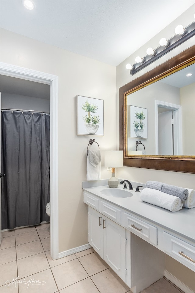 bathroom featuring tile patterned floors, vanity, and toilet