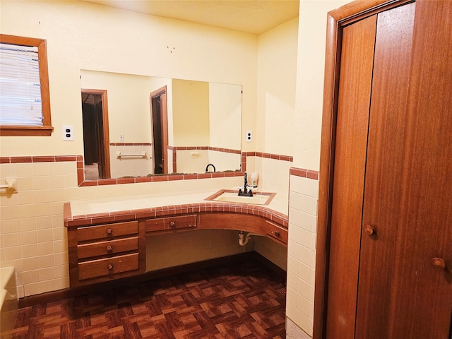 bathroom featuring vanity, parquet floors, and tile walls