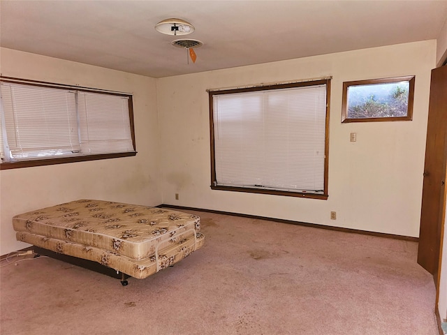 unfurnished bedroom with light carpet