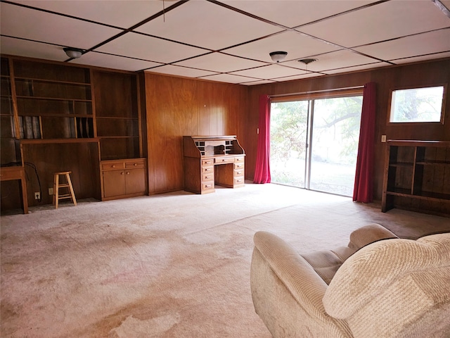 living room with carpet flooring and wood walls