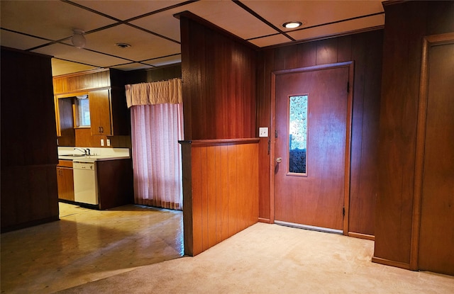 interior space featuring sink and wood walls