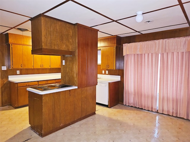 kitchen featuring kitchen peninsula, wooden walls, dishwasher, and electric stovetop