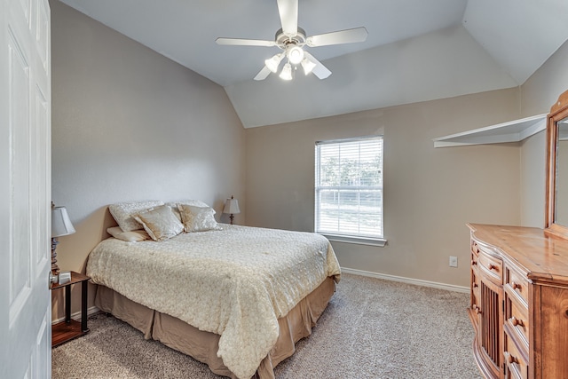 carpeted bedroom featuring lofted ceiling and ceiling fan