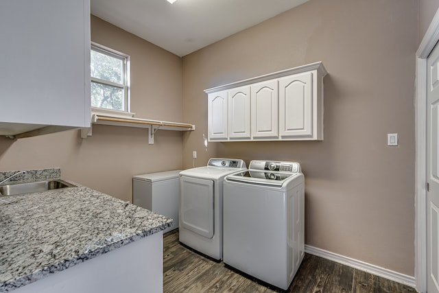 washroom featuring cabinets, independent washer and dryer, dark hardwood / wood-style flooring, and sink