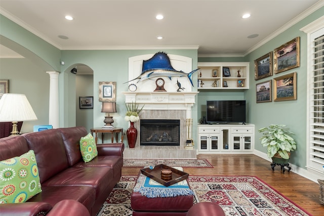 living room featuring ceiling fan, crown molding, light hardwood / wood-style flooring, and decorative columns